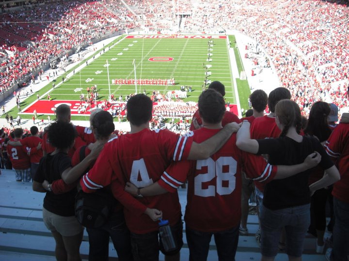 Graduate students in the PoliSci program sing to Carmen Ohio at an Ohio State football game.